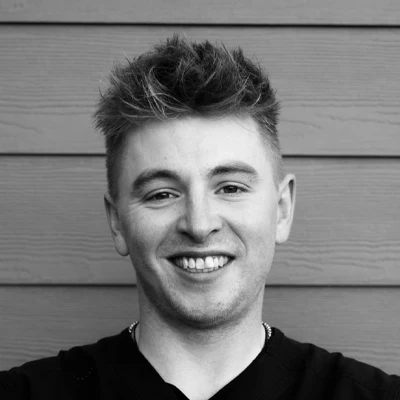 Bryan Polmear smiling. The photo is black and white.